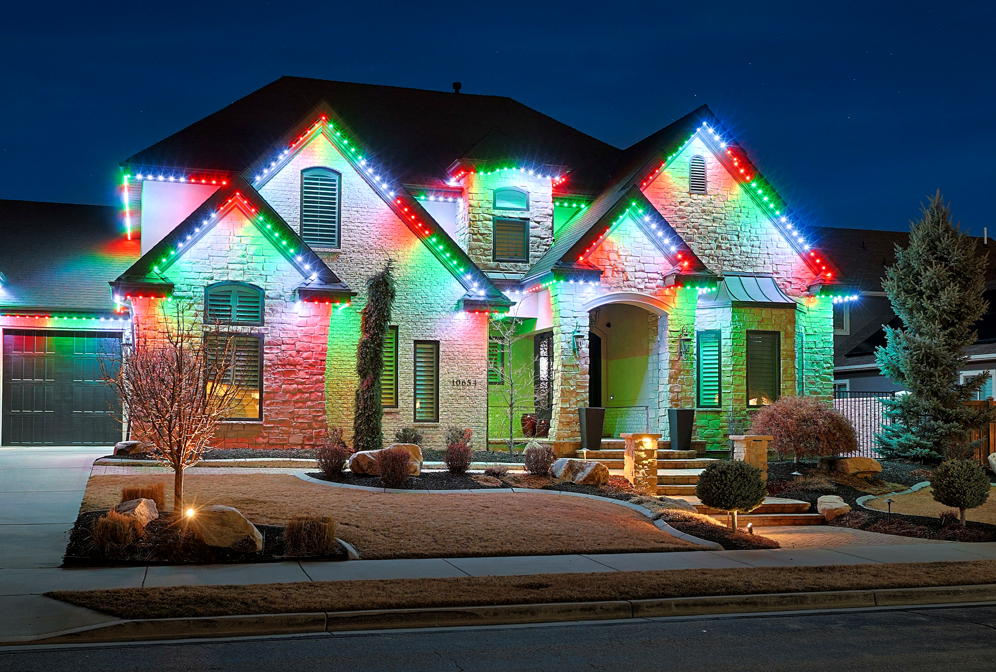 Residential home with Christmas red and green roofline lighting